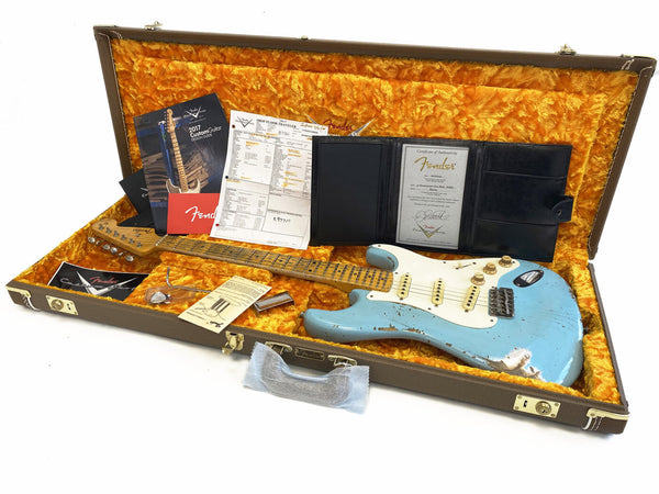 Fender Custom Shop relic light blue Stratocaster electric guitar in vintage case with certificate of authenticity, Fender manuals, and accessory papers displayed on orange plush interior