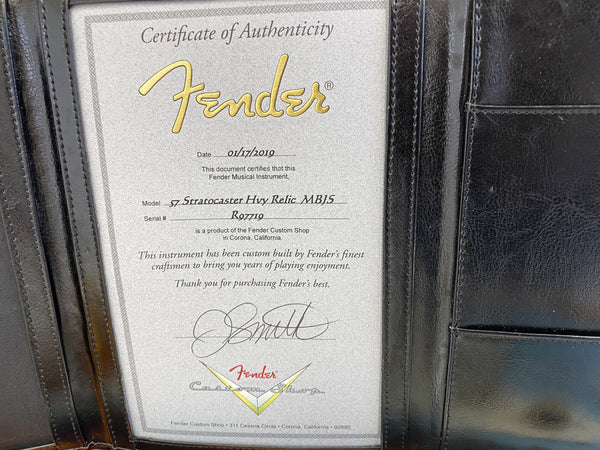 Fender Certificate of Authenticity for 57 Stratocaster Hvy Relic MB1S with serial number R97719, dated 01/17/2019, issued by Fender Custom Shop in Corona, California, displayed in a black leather folder.
