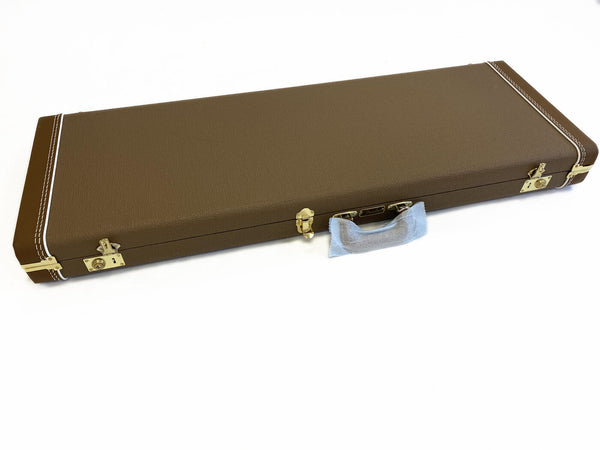 Brown Fender hard shell guitar case with gold latches and handle covered in protective wrap, isolated on white background