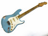 Vintage Fender Stratocaster electric guitar in distressed surf green finish with maple neck and white pickguard, showing wear and aging signs