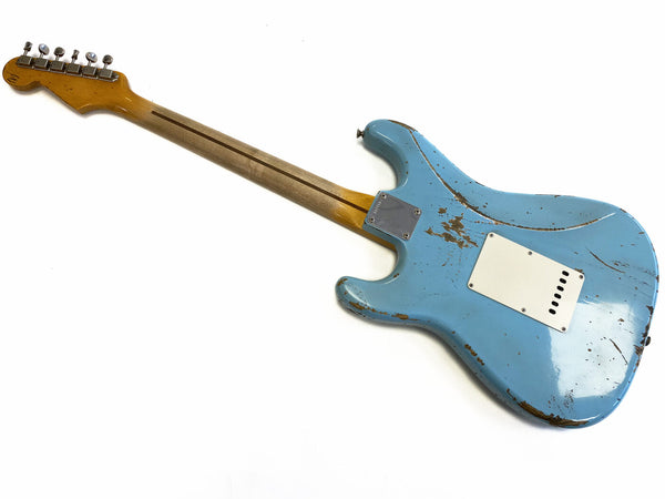 Vintage blue electric guitar body with neck showing wear and relic finish, back view on white background