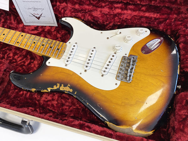 Vintage Fender Stratocaster electric guitar with sunburst finish and maple neck in red velvet-lined hard case