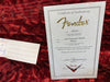 Fender Certificate of Authenticity for 1956 Stratocaster Relic guitar with serial number R86544 dated 08/17/16 on red plush guitar case lining