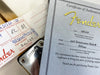Fender Certificate of Authenticity for 1956 Stratocaster Relic with serial number R86544 and Fender custom shop inspection tag and guitar neck plate.