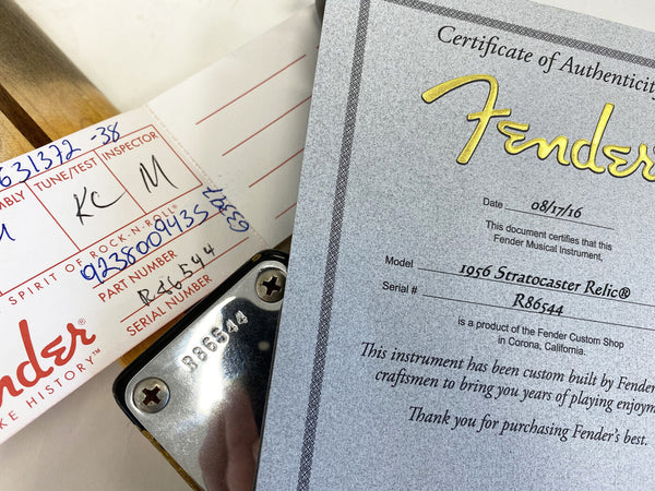 Fender Certificate of Authenticity for 1956 Stratocaster Relic with serial number R86544 and Fender custom shop inspection tag and guitar neck plate.