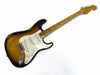 Vintage Fender Stratocaster electric guitar in sunburst finish with white pickguard and maple fretboard showing wear and aging