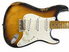 Vintage sunburst electric guitar with three single-coil pickups and white pickguard showing wear and relic finish