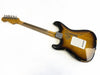 Vintage Fender Stratocaster electric guitar back view with sunburst finish and worn, relic condition showing wood grain and metal neck plate on white background