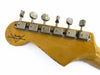Vintage Fender Custom Shop guitar headstock with six vintage tuning pegs on light wood background