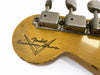 Close-up of Fender Custom Shop guitar headstock with vintage tuning pegs and worn natural wood finish