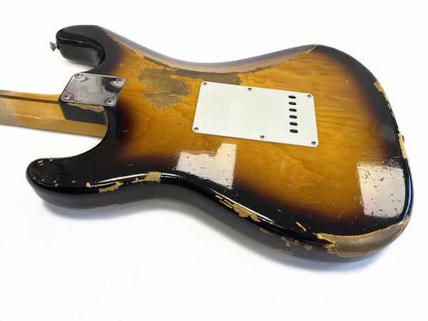 Rear view of vintage sunburst electric guitar body with white backplate and worn finish showing natural wood and chipped paint