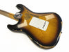 Vintage sunburst electric guitar body with worn and chipped finish, showing aged wood grain and white plastic backplate, photographed on white background