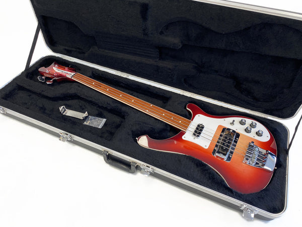 Rickenbacker 4001 electric bass guitar in red sunburst finish with chrome hardware and white pickguard in black plush-lined hardshell case with accessories