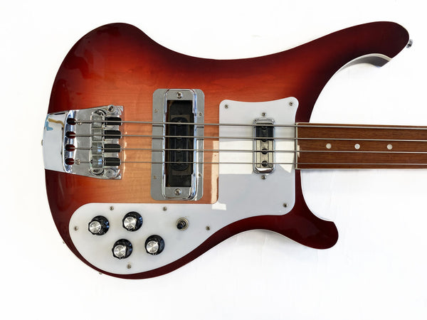 Vintage sunburst electric bass guitar with chrome hardware and four control knobs on white pickguard