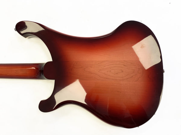 Back of electric guitar with sunburst finish and visible wood grain on white background