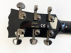 Close-up of black guitar headstock with six Grover tuning pegs, model number SG1820A, made in Japan, and CE certification mark