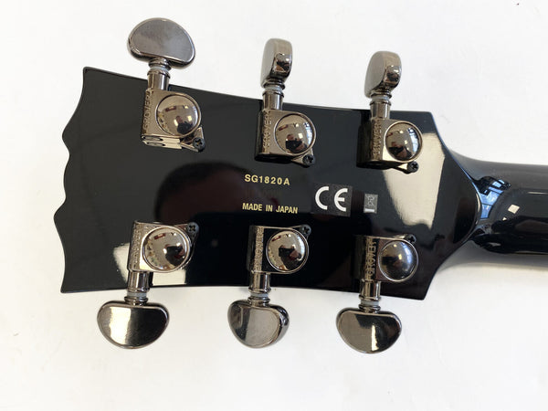 Close-up of black guitar headstock with six Grover tuning pegs, model number SG1820A, made in Japan, and CE certification mark