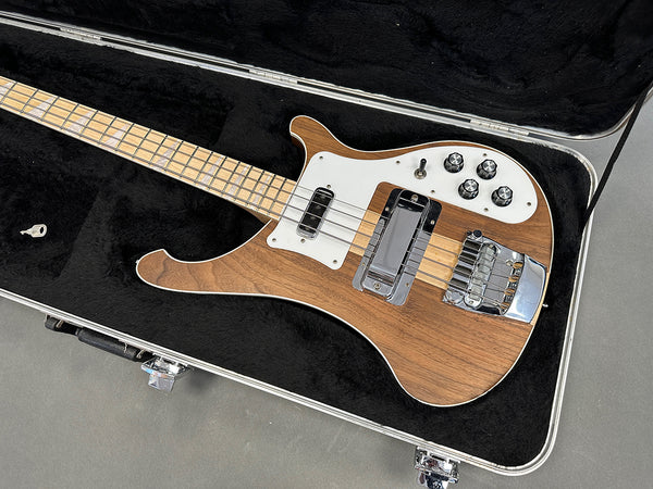 Vintage Rickenbacker 4001 bass guitar with natural wood finish and white pickguard in black plush-lined hard case