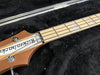 Rickenbacker bass guitar headstock and maple fretboard with chrome tuning pegs in black soft case interior