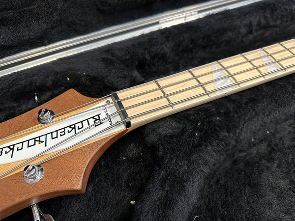 Rickenbacker bass guitar headstock and maple fretboard with chrome tuning pegs in black soft case interior