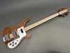 Rickenbacker electric bass guitar with natural wood finish, maple neck, white pickguard, and chrome hardware on gray background
