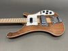 Electric bass guitar with natural wood finish, white pickguard, chrome bridge, and control knobs on gray background
