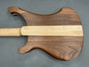 Back of electric guitar body with natural walnut wood and maple center stripe neck joint on gray background
