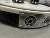 Close-up of a black and white electric guitar input jack plate with "Rickenstand R." engraving and chrome hardware screws at Coffee House Guitars.
