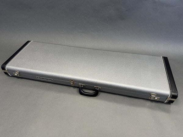 Birkenbacher silver and black hard guitar case with handle and metal clasps on gray background