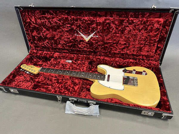 Vintage Fender Telecaster electric guitar in natural finish with white pickguard in black hardshell case lined with red plush interior