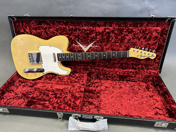 Vintage Fender Custom Shop Telecaster electric guitar in blonde finish with white pickguard, displayed inside black hard case with red plush interior lining.