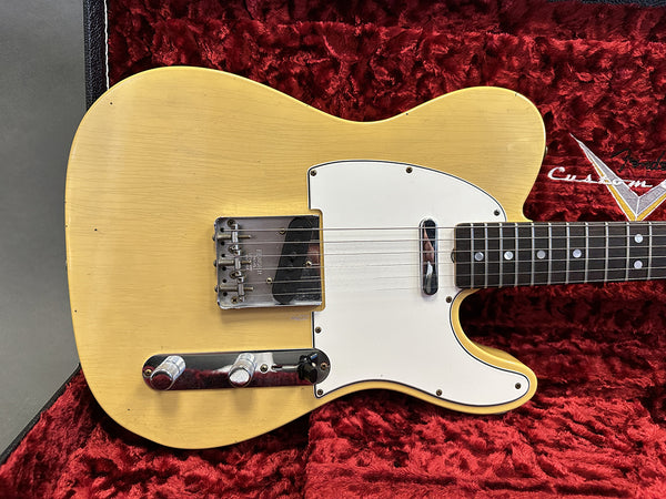 Vintage cream Fender Telecaster electric guitar body with white pickguard and chrome control knobs on red plush-lined Fender Custom case interior