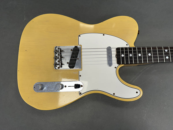 Vintage yellow solid body electric guitar with white pickguard and chrome hardware