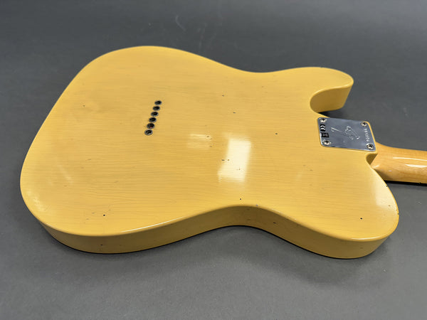 Back side of vintage yellow electric guitar body with metal neck plate and string ferrules on gray background for sale at Coffee House Guitars