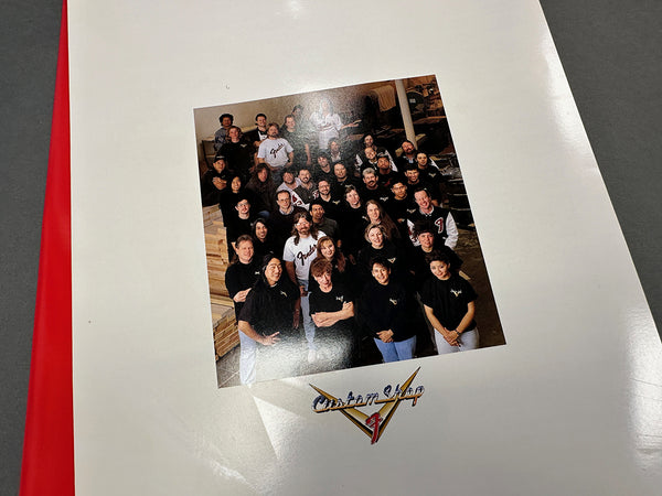 Fender Custom Shop team group photo on white album cover with red edge background, showcasing Fender Custom Shop logo.