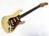 Vintage Fender Stratocaster electric guitar with worn off-white body and tortoiseshell pickguard, maple neck, and rosewood fretboard.