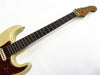 Vintage Fender Stratocaster electric guitar neck and partial body with worn cream finish and tortoiseshell pickguard on white background