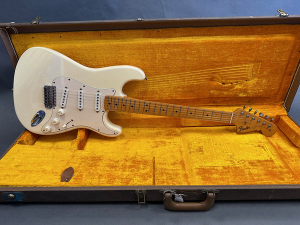 Vintage cream Fender Stratocaster electric guitar with maple neck in open yellow plush lined hard case