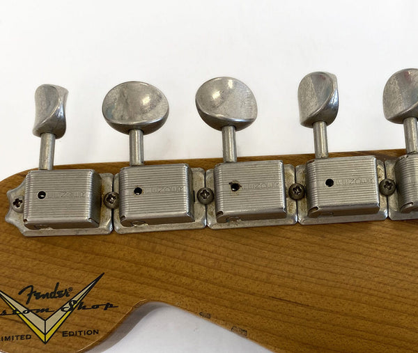 Close-up of vintage Fender Custom Shop guitar tuning pegs on natural wood headstock with Limited Edition logo.