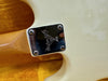 Close-up of guitar neck plate with Custom Shop USA engraving and serial number CWA01492 on cream electric guitar body