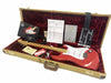 Fender Custom Shop 60th Anniversary Stratocaster in red with maple neck and white pickguard, displayed in open tweed hard case with red plush interior, accessories including certificate of authenticity, owner's manual, Fender Custom Care card, strap, and guitar cable.