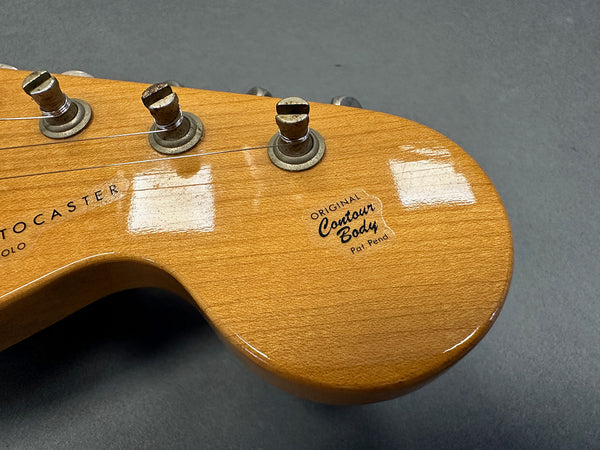 Close-up view of vintage Fender Telecaster guitar headstock showcasing original contour body decal and tuning pegs on natural wood finish
