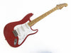 Red Fender Stratocaster electric guitar with maple neck and white pickguard isolated on white background