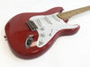Red electric guitar with white pickguard, three single-coil pickups, volume and tone control knobs, and maple neck on white background