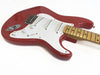 Red electric guitar with white pickguard and maple fretboard, showing volume and tone knobs and three single-coil pickups on white background