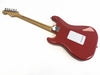 Back view of red electric guitar with maple neck and chrome hardware on white background