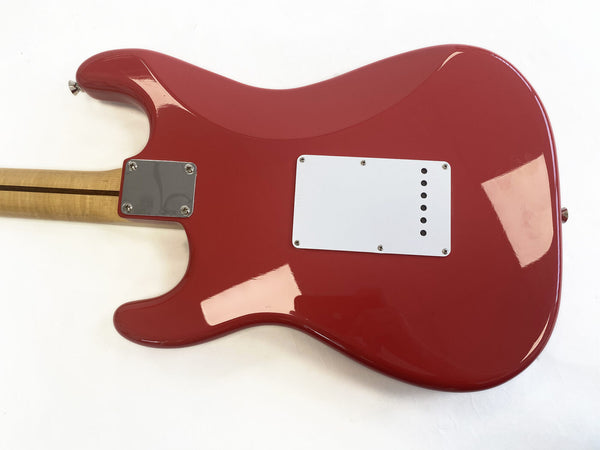 Red electric guitar body back with white plastic control cavity cover and maple neck attached with metal neck plate, photographed on white background