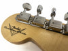 Close-up of Fender Custom Shop guitar headstock with vintage-style tuning machines and natural wood finish