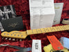 Fender Custom Shop right-hand 1951 Nocaster NOS guitar headstock and maple fretboard, certificate of authenticity, Fender custom care booklet, sales order details, guitar strap, and caution tag on red plush case lining.