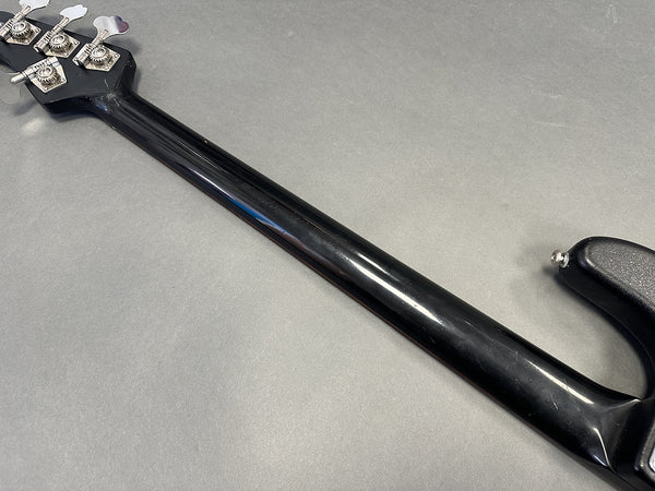 Black electric bass guitar neck and tuning pegs on gray background, Coffee House Guitars product listing image